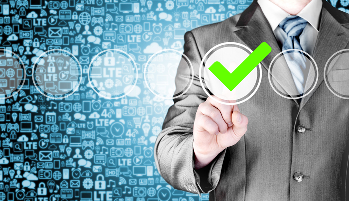 Business man pressing modern button with green ticking check box.